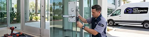 Tim's Locksmith Service technician installing a commercial lever handle on a glass storefront door in Oxnard, California. Master key systems, access control, panic bars, and commercial-grade hardware for Ventura County businesses.