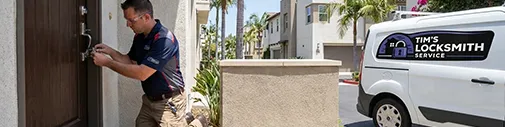 Tim's Locksmith Service technician replacing a front door deadbolt at a home in Coronado, California. Residential lock installation, repair, rekeying, and smart lock services throughout San Diego County.