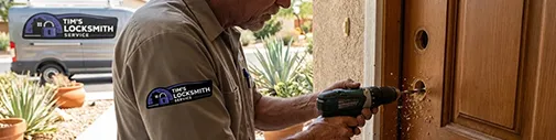 Tim's Locksmith Service technician drilling a deadbolt bore on a residential front door in Ventura, California. Lock installation, repair, replacement, rekeying, and smart lock setup for homes across Ventura County.