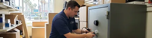 Tim's Locksmith Service technician servicing a commercial safe with an electronic dial at a business in Poway, California. Safe opening, combination changes, vault lock repair, and electronic safe programming throughout San Diego County.